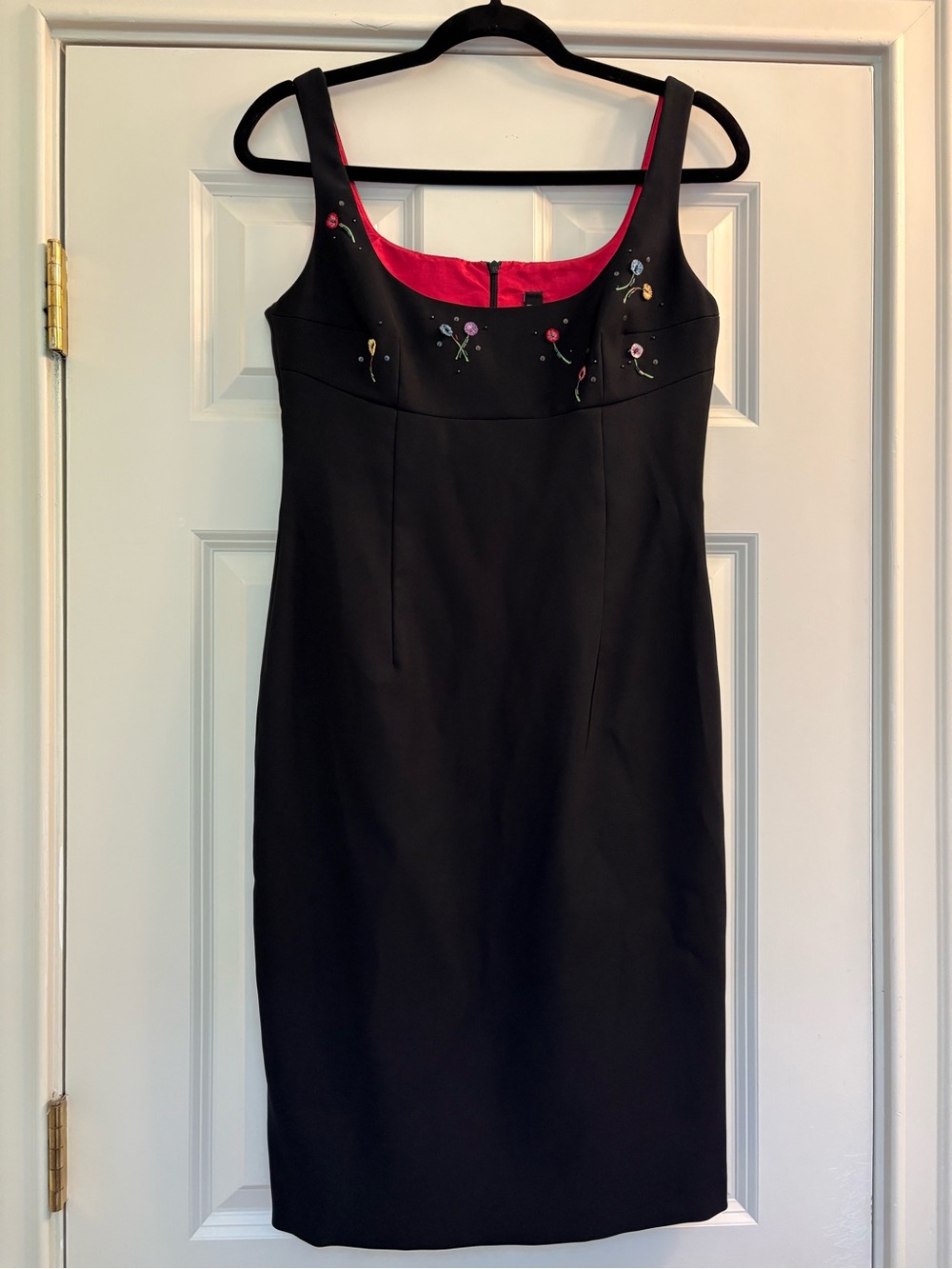 Black Sleeveless Sheath Dress with Pink Lining and Embroidered Detail.